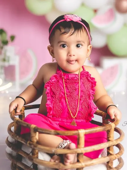 A sweet portrait from a watermelon-themed first birthday. This little girl looks so adorable sitting in a rustic basket.