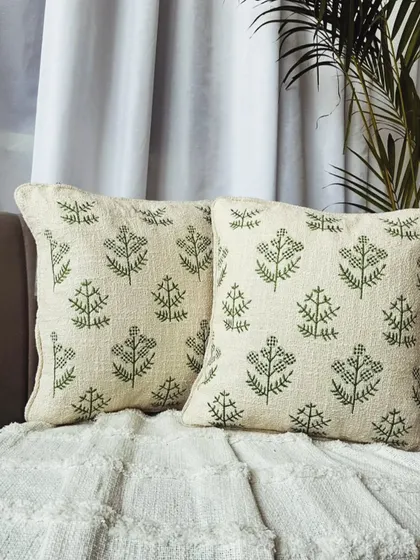 A lovely green botanical pattern embroidered on a natural slub cotton base. This cushion cover is perfect for a fresh, earthy home aesthetic.