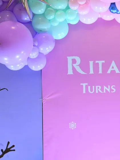 A detail from Ritanya's 'Frozen' party, showing the 'Turns One' sign on the backdrop.