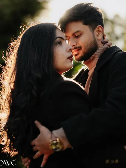 A beautifully backlit close-up of a couple embracing, with the golden hour sun creating a stunning rim light effect.