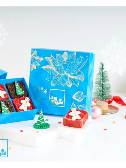 Our mini celebration box gets a festive makeover for Christmas, filled with adorable gingerbread-themed brownies.