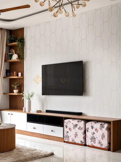 This TV unit features a unique wallpapered background and a combination of wood and white finishes. The design includes open shelves for decor and ottomans tucked underneath for extra seating.