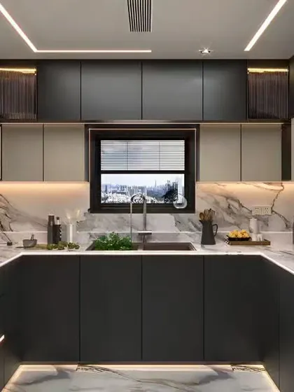 This U-shaped kitchen is designed for the serious cook, with dark matte cabinets and a stunning marble backsplash that extends up the wall. The integrated lighting under the cabinets and in the ceiling ensures the space is both moody and functional.