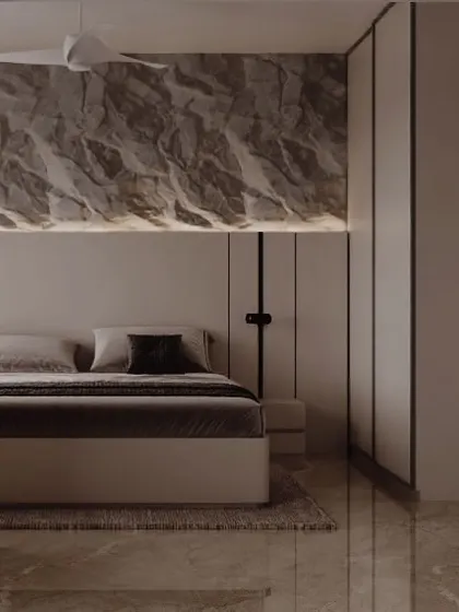 This bedroom design plays with bold textures. A dramatic, rock-like textured panel with backlighting serves as a powerful headboard, contrasting with the smooth, clean lines of the surrounding furniture.