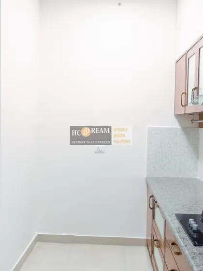 A compact and efficient kitchen from our Prestige Shantiniketan project. The warm wood cabinets and granite countertop create a classic and timeless look.
