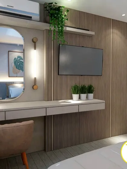 A close-up of the integrated TV and dressing table, featuring an oval mirror and stylish wall sconces.
