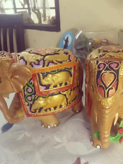 Two of my painted wooden elephants shown together, perfect as a pair for home decor.