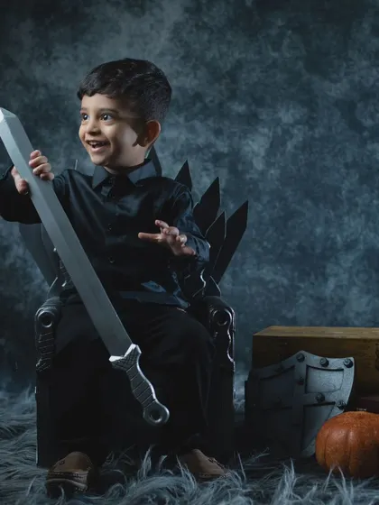 This little warrior is excited to wield his sword, ready for any battle that comes his way.