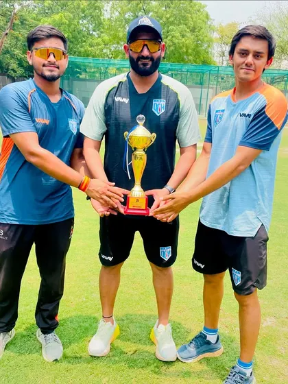 The coaching team with the trophy. We work as a team behind the scenes to ensure the players succeed on the field.