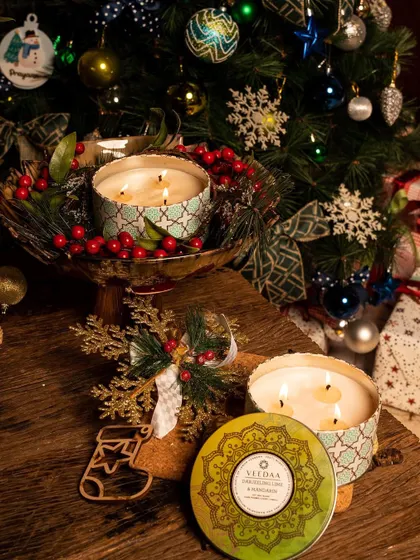 It's beginning to smell a lot like Christmas. Our three-wick tin candles, surrounded by festive greenery and ornaments, are the perfect way to bring the scent of the holidays into your home.