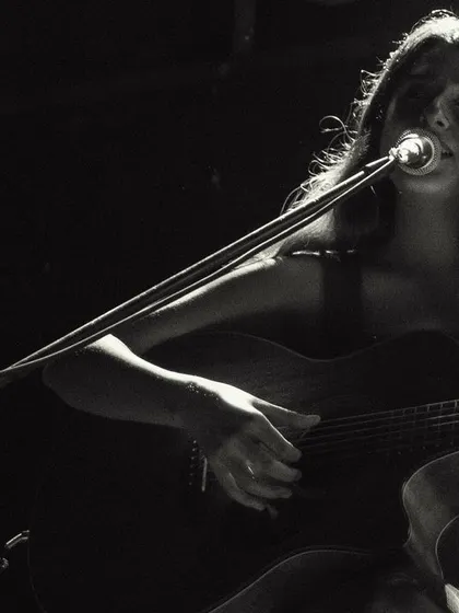A black and white close-up of me singing during a duo performance. The focus is purely on the music and emotion.