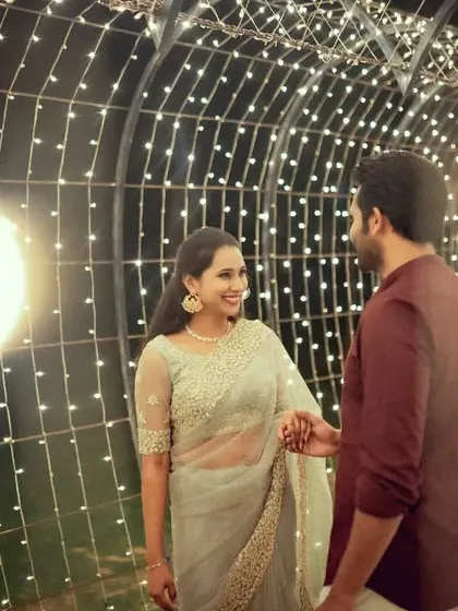 A romantic pre-wedding photo in a tunnel of lights, capturing the magical glow and the couple's connection.