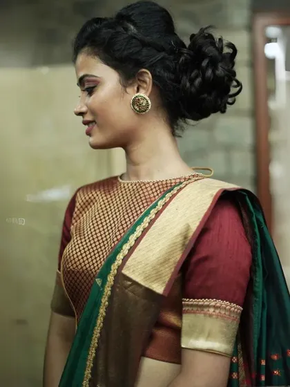 This model showcases an elegant updo, which perfectly highlights her round, gold-toned traditional stud earrings.