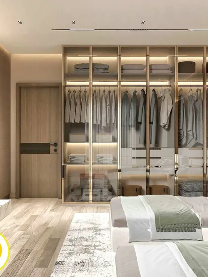 A view of the bedroom showing the expansive glass wardrobe with internal lighting, which not only provides ample storage but also makes the room feel larger and more open.