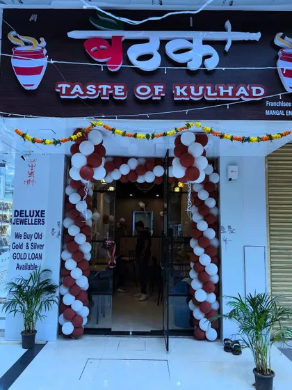 Another angle of the 'Baithaak' cafe opening, highlighting the traditional marigold garland paired with the modern balloon arch.