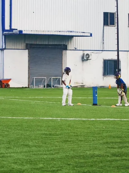 A wide shot of the U10 practice match, showing the setup with cones and wickets, creating a professional environment for kids.