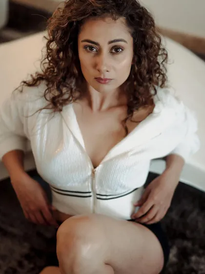 An intense and direct portrait from the white shirt series. The high-angle shot and the model's strong eye contact create a compelling and powerful image.