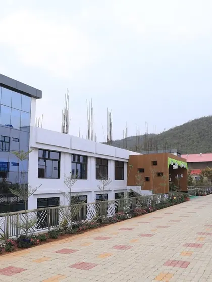 The academic building at UNACCO School during construction, showing the structure taking form.