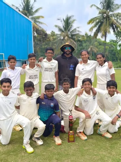 Our mixed team of boys and girls with their coach and a trophy, showcasing our inclusive environment.
