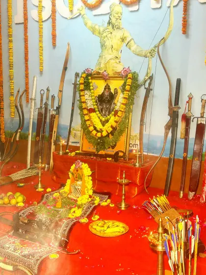 A closer view of the decorated altar, with a statue of Lord Parashuram, the ultimate Guru of martial arts. The weapons are blessed under his divine watch.