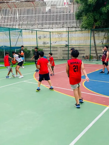 A junior player practices dribbling with both hands, a fundamental skill for all players.