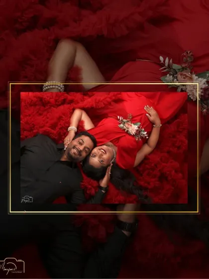 A creative, framed perspective of a couple's love. This overhead shot captures an intimate moment, beautifully composed within a golden frame against a backdrop of red tulle.