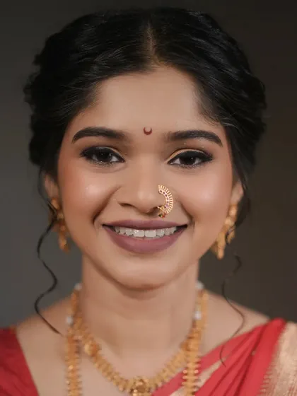 A stunning close-up of the bride. Her makeup features defined, smoky eyes and a neutral matte lip, a classic combination that always looks elegant.