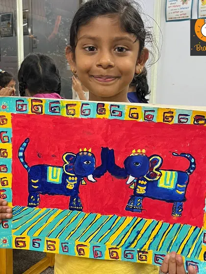 Inspired by traditional Indian art, this painting of two elephants is wonderfully symmetrical and vibrant. The student did a fantastic job with the bold red background and decorative borders.
