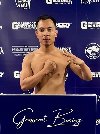 A fighter poses confidently on the scales.