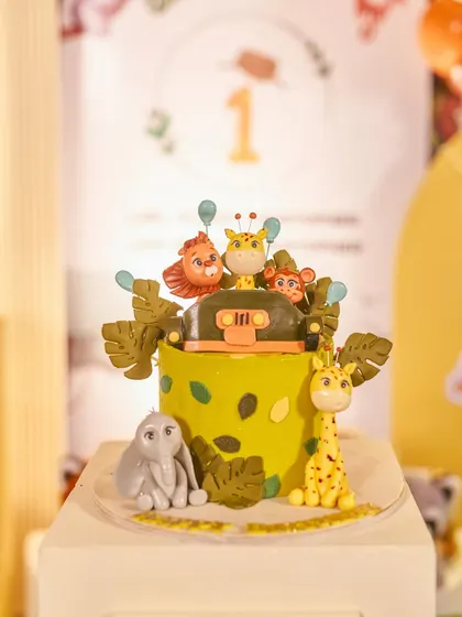 A jungle-themed cake that's almost too cute to eat. The fondant animals and safari jeep topper are a perfect match for a wild birthday adventure.