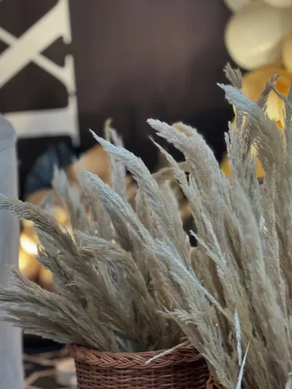 More details of the pampas grass in wicker baskets, contributing to the modern-boho aesthetic of the birthday party.