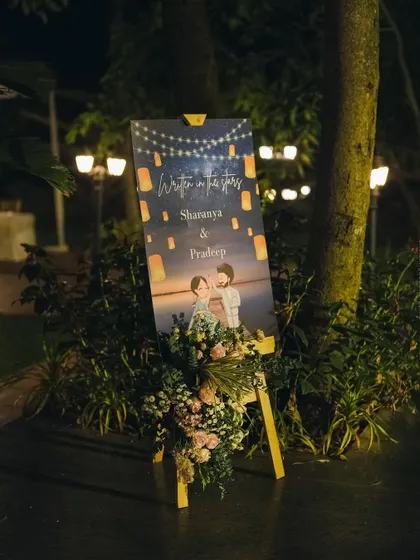 A personalized welcome easel with a cute caricature of the couple, adding a whimsical and personal touch to the reception.