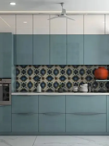 A sleek straight kitchen with glossy blue-green cabinets and handleless drawers. A built-in oven and patterned backsplash complete this contemporary look.