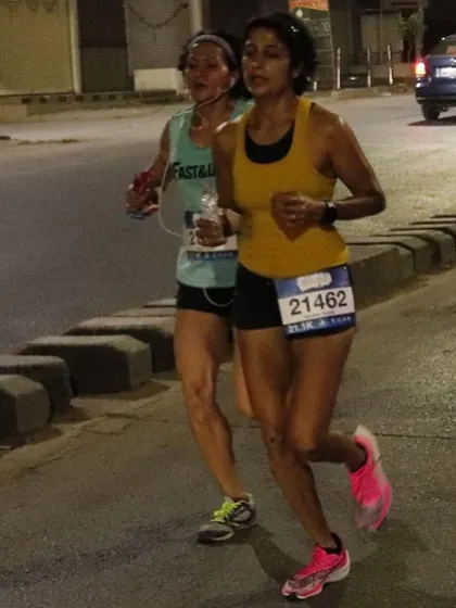 Running alongside one of my athletes during a race. This shows the personal connection and support that is a hallmark of my coaching.