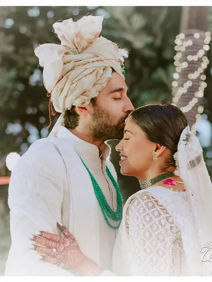 Another angle of the forehead kiss, showcasing the bride's serene happiness.