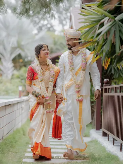 A candid shot of the couple walking and sharing a look of love. This captures their natural chemistry and the happiness of their wedding day.
