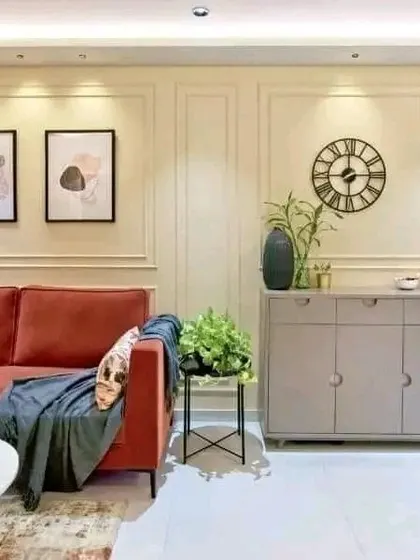 This image shows how I can create a complete living room look, with wall molding, modern art, and a storage console that complements the sofa and decor.