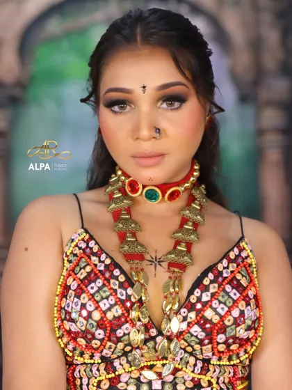 A direct portrait showing the intensity of the smokey eyes and the traditional bindi and nose pin. The makeup is powerful yet clean.