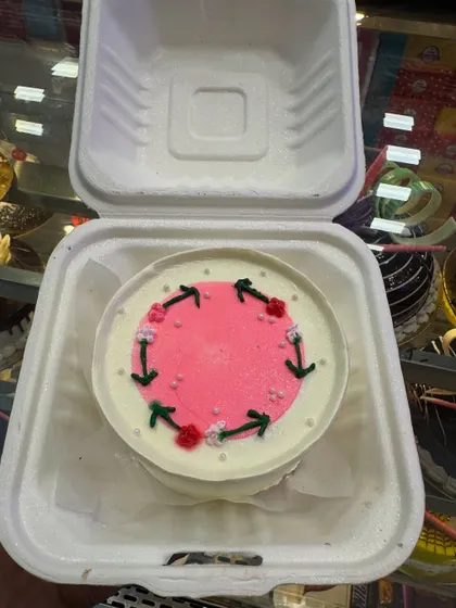 A minimalist bento cake with a simple arrow and floral design. It shows that even the smallest cakes can have a unique and artistic touch.