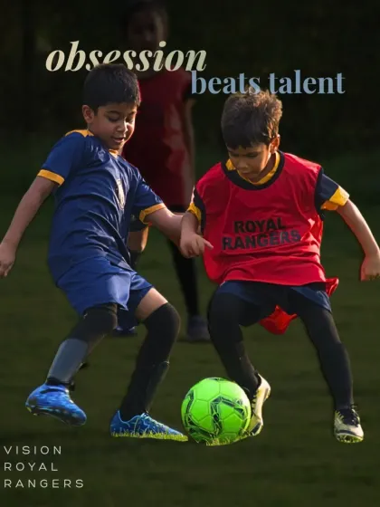 Obsession beats talent. Two young players battle for the ball, showing the competitive fire and determination that we nurture.