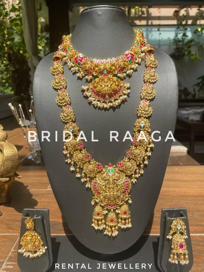 A beautiful temple jewellery set with Kemp stones. The choker and long haram both feature intricate floral and peacock motifs.