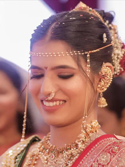 A beautiful, happy moment. The makeup is soft and subtle, focusing on enhancing her natural beauty.