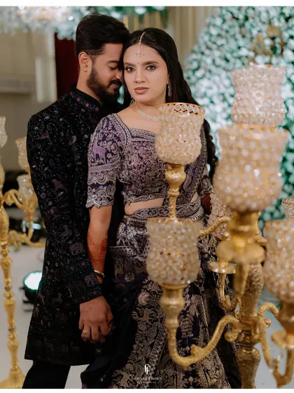 An intimate portrait of the couple amidst the warm glow of candles at their reception.