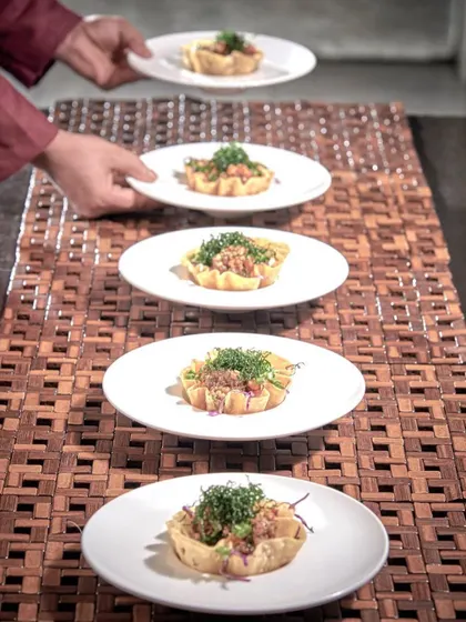 Service is an art form. Our professional team ensures every dish, like these beautifully arranged appetizers, is presented with grace and precision, allowing you to relax and enjoy the experience as much as your guests.