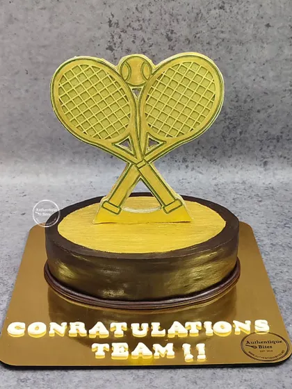 We created this special trophy cake for the Delhi Club Tennis Championships. The design features a golden tennis racket trophy on a chocolate and gold base.