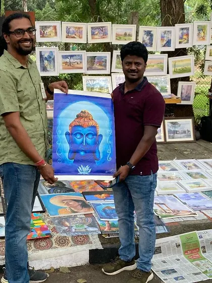 A happy customer with his new painting from my stall.