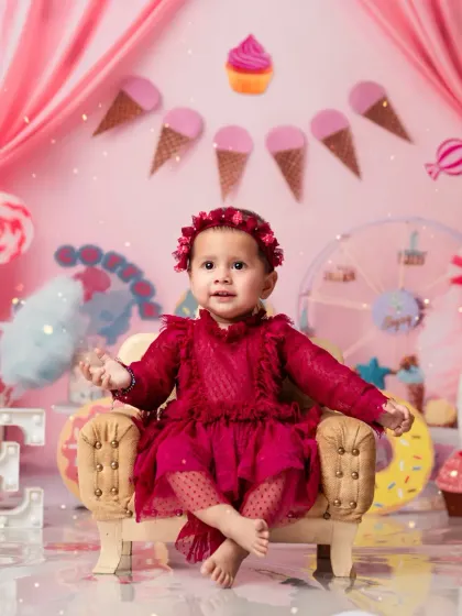 Pretty in pink! A lovely portrait from a Candy Land first birthday shoot, complete with a mini armchair.