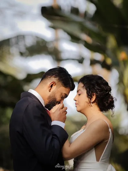 The groom kissing his bride's hand, a classic gesture of love and respect.