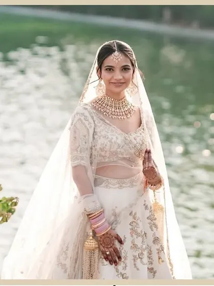 Vidha looking like a dream by the water. Her all-white lehenga was paired with a very natural, "no-makeup" makeup look for her day wedding.