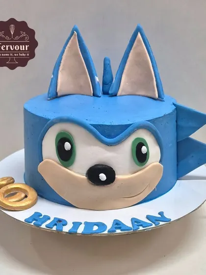 A 3D Sonic the Hedgehog cake that looks just like the speedy character. This design uses whipped cream and minimal fondant to create Sonic's iconic face, perfect for a gaming-themed party.
